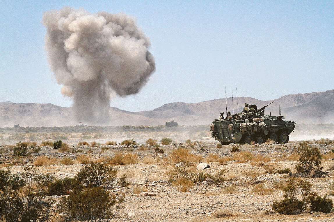 Eine Explosion in einer wüstenartigen Gegend und ein Panzer