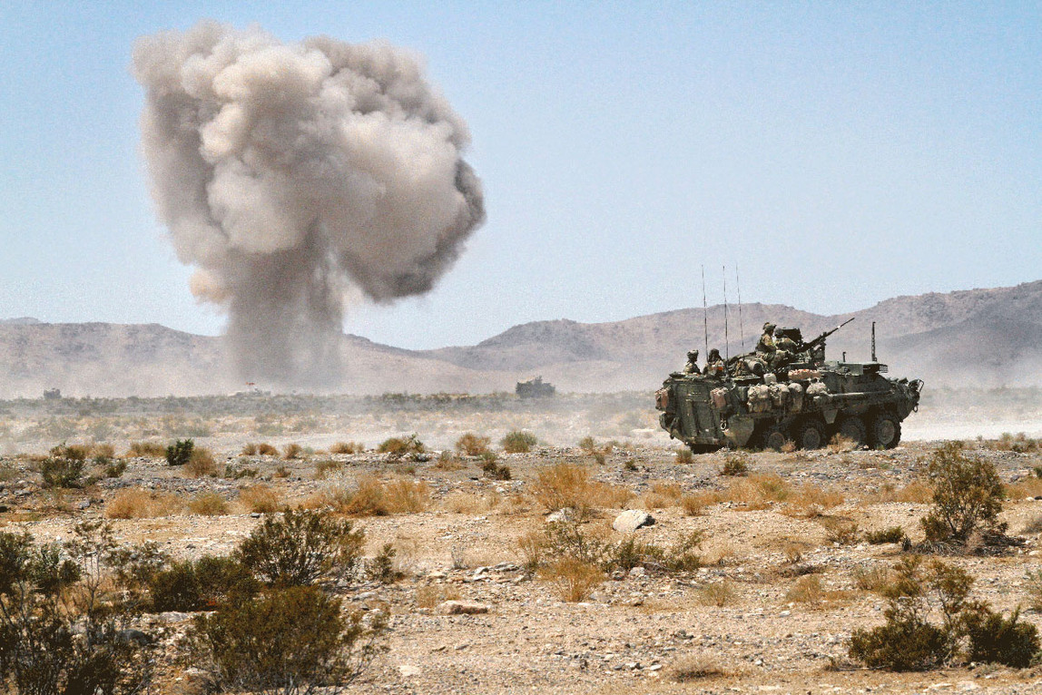 Eine Explosion in einer wüstenartigen Gegend und ein Panzer